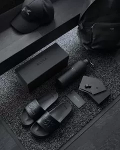 black sony remote control beside black leather bag