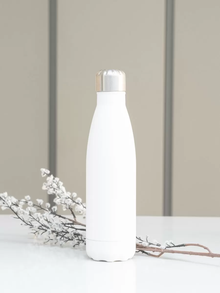 white bottle on white table