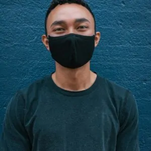 man in blue crew neck shirt wearing black mask