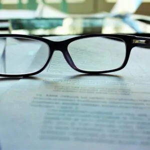 black-framed eyeglasses on white printing paper